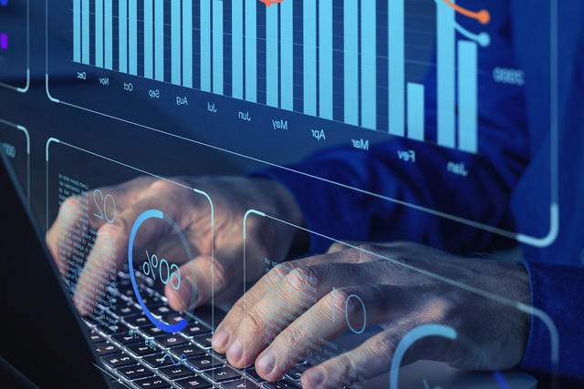 Hands typing on a laptop keyboard overlaid with holographic charts and data visualizations, representing data analytics, financial technology, and digital reporting.