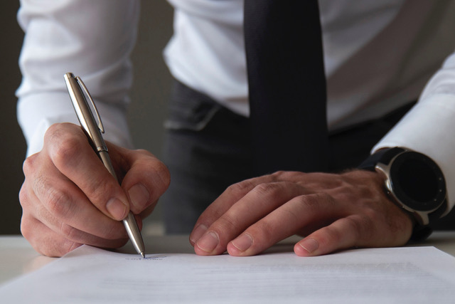 Man signing a contract