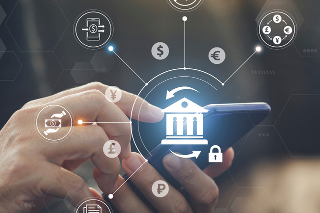 Close-up of hands using a smartphone with floating icons representing global digital banking, currency exchange, and fintech connectivity.
