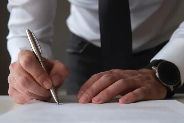 A man signing a document